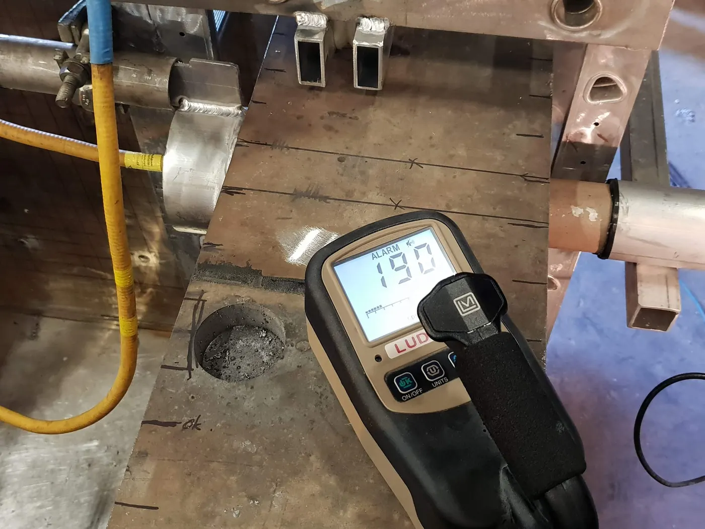 Radiation survey meter in use beside a component