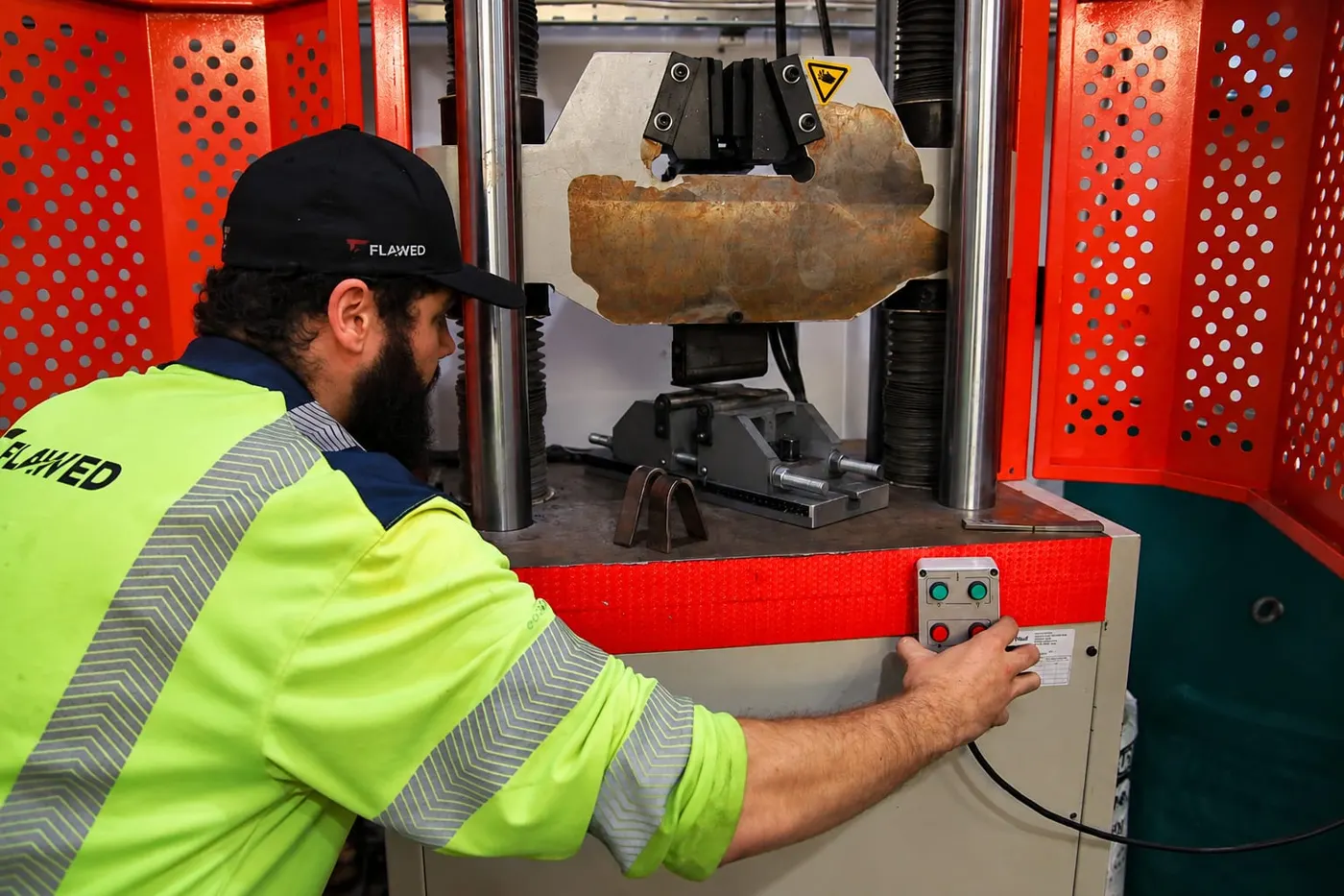 Technician operating the tensile testing machine
